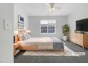 A bright bedroom featuring neutral walls and flooring and furnished with light colored furniture at 7818 Spungold St, Raleigh, NC 27617