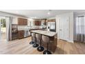 Modern kitchen with stainless steel appliances, center island, and bar seating at 8710 Kenridge Ln, Fuquay Varina, NC 27526