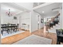 Open-concept living area with hardwood flooring, leading to a dining room and staircase at 921 Alden Bridge Dr, Cary, NC 27519