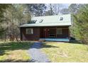 Charming home exterior featuring a red front door and a welcoming porch with a built-in bench at 9511 Collins Creek Dr, Chapel Hill, NC 27516
