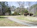Property showcasing a residence with a metal roof, nestled among the trees at 9511 Collins Creek Dr, Chapel Hill, NC 27516