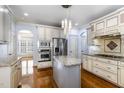 Bright kitchen featuring granite countertops, stainless steel appliances, and custom cabinetry at 10016 Porto Fino Ave, Wake Forest, NC 27587