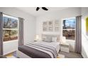 Bright bedroom with large windows, neutral decor, and ceiling fan at 1012 W Webb Ave, Burlington, NC 27217