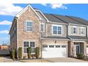 Attractive townhome featuring stone accents, a gray siding and a spacious two-car garage at 1029 Benay Rd, Morrisville, NC 27560