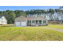 An inviting single-story home boasts a two-car garage and well-maintained landscaping at 1076 Nc 55, Coats, NC 27521