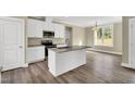 Open kitchen featuring a central island, stainless steel appliances, and ample cabinet space at 1076 Nc 55, Coats, NC 27521