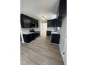 Stylish kitchen features black cabinets, stainless steel appliances, white countertops, and modern backsplash at 1116 Shadywood Ln, Raleigh, NC 27603