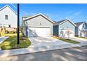 A detached two-car garage that includes modern lighting, landscaping and wide driveway at 113 Weavers Grove Dr, Chapel Hill, NC 27514