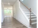 Bright entryway with hardwood floors and stairs leading to the second floor at 114 Tee Time Ter, Benson, NC 27504
