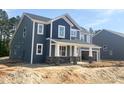 Charming new two-story home with a welcoming front porch and attached two car garage, set on a spacious lot at 114 Tee Time Ter, Benson, NC 27504