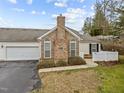 View of home showcasing the attached garage and well-maintained landscaping at 1146 Blue Bird Ln, Wake Forest, NC 27587