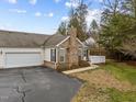 Exterior view of the home with attached garage, neat landscaping, and blue skies at 1146 Blue Bird Ln, Wake Forest, NC 27587