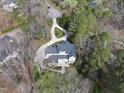 Aerial view of the backyard with patio and tree coverage and traditional home with black shutters at 12101 Lockhart Ln, Raleigh, NC 27614
