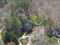 Aerial view highlighting the property's landscaping, circular driveway, and proximity to surrounding trees at 12101 Lockhart Ln, Raleigh, NC 27614