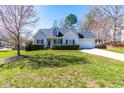 Charming one-story home with manicured lawn, attached garage, and inviting front porch at 136 Mayflower Way, Clayton, NC 27527