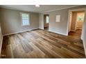 Open-concept living area with durable wood-look floors and a view leading to the kitchen and bathroom at 1405 Parham St, Henderson, NC 27536