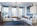 Stylish living room with large windows, comfortable sectional sofa, and chic decor offers relaxation at 1485 Hasse Ave, Apex, NC 27502