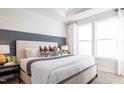 Bright main bedroom features a large bed, decorative wall accents, and ample natural light at 1485 Hasse Ave, Apex, NC 27502