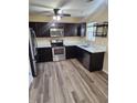 Charming kitchen featuring new wood flooring, stainless steel appliances, and modern countertops at 1536 Ricochet Dr, Raleigh, NC 27610