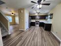 Open concept living area featuring new wood flooring and stainless steel appliances at 1536 Ricochet Dr, Raleigh, NC 27610