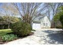 Spacious driveway leading to a well-maintained home with mature trees offering ample shade at 1705 Mcrae Pl, Hillsborough, NC 27278