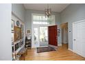 Bright foyer with a hardwood floor, an open doorway, and decor, creating an inviting entrance at 1705 Mcrae Pl, Hillsborough, NC 27278