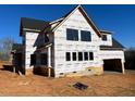 A two-story home is under construction and has an attached two-car garage on a sunny day at 171 Dairymont Dr, Pittsboro, NC 27312