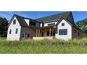 Rear exterior of a new two-story home with a covered porch at 171 Dairymont Dr, Pittsboro, NC 27312