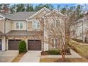 Charming townhome featuring stone accents, a private garage, and beautifully landscaped surroundings at 200 Mariah Towns Way, Garner, NC 27529