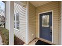 Inviting front entrance featuring a stylish blue door, modern lock, and well-kept surroundings at 200 Mariah Towns Way, Garner, NC 27529