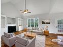 Staged living room featuring a fireplace, built-in shelving, large window, and stylish, comfortable seating at 2012 Castana Ct, Willow Springs, NC 27592