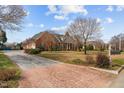 Spacious home features a circular driveway and a beautifully landscaped front yard at 205 Parliament Pl, Dunn, NC 28334