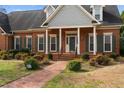 Attractive brick home with a neatly landscaped yard and brick pathway leading to the entrance at 205 Parliament Pl, Dunn, NC 28334