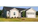 Side view of a single-story home featuring gray siding, white trim, and a well-maintained front lawn at 207 Golfview Ave, Benson, NC 27504