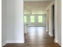Bright living room with hardwood floors and large windows providing ample natural light at 207 Golfview Ave, Benson, NC 27504