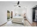 A bright bedroom features modern lighting, a ceiling fan, neutral tones, and sliding glass doors at 208 Martin Luther King Jr Blvd, Raleigh, NC 27601