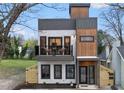 A modern multi-story condo features a light stone facade, wood accents, and black-trimmed windows and doors at 208 Martin Luther King Jr Blvd, Raleigh, NC 27601