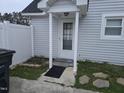 Exterior shot of the house highlighting the entrance with a white picket fence detail and stone pathway at 225 Sebastian Way, Rocky Mount, NC 27804