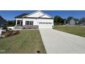 This single Gathering home features a two car garage, well maintained yard, and long driveway at 228 Pecan Valley Way, Four Oaks, NC 27524