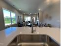 Modern kitchen with stainless faucet, open to a spacious living area with a fireplace and ample natural light at 228 Pecan Valley Way, Four Oaks, NC 27524