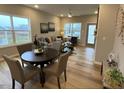 Bright living area with lots of natural light, wood floors, and neutral décor at 228 Pecan Valley Way, Four Oaks, NC 27524