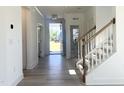 Entryway of home with a staircase, wood handrail and a view of the front door at 245 Golfview Ave, Benson, NC 27504