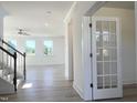 Bright entryway with light wood floors, a staircase with wood handrail, and lots of natural light at 245 Golfview Ave, Benson, NC 27504
