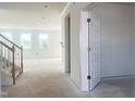 Bright entryway with white walls, staircase with wooden handrail, and multiple windows for natural light at 245 Golfview Ave, Benson, NC 27504