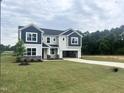 Stunning two-story home with well-maintained lawn and a two-car garage, set in a peaceful, wooded location at 245 Golfview Ave, Benson, NC 27504