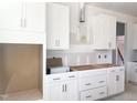 Kitchen featuring white cabinets, stainless steel hardware, and provision for modern appliances, still under construction at 245 Golfview Ave, Benson, NC 27504
