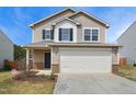 Inviting two-story home featuring neutral siding, a two-car garage and a well-maintained front yard at 2527 Girvan Dr, Fuquay Varina, NC 27526