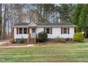 Well-maintained single-story home with manicured lawn and attractive landscaping at 2624 Brad Ct, Apex, NC 27539