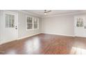 Spacious living room with laminate flooring, neutral walls, and dual exterior doors at 2624 Brad Ct, Apex, NC 27539