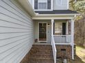 A welcoming front entry featuring brick steps and a door with seasonal wreath at 2760 Clifton Ave, Creedmoor, NC 27522